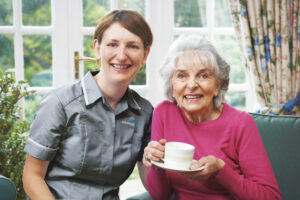 home carer with client drinking a cup of tea